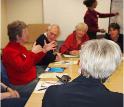 A group of people discussing around a table.